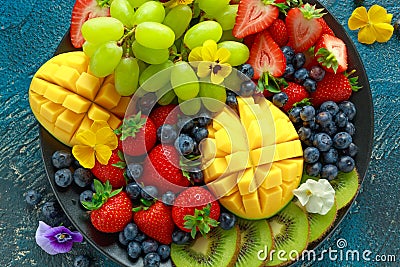 Colorful Mixed Fruit platter with Mango, Strawberry, Blueberry, Kiwi and Green Grape. Healthy food Stock Photo