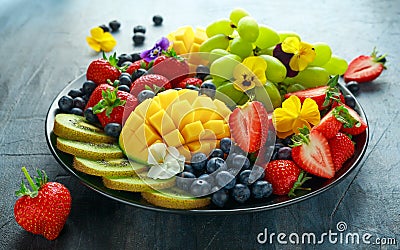 Colorful Mixed Fruit platter with Mango, Strawberry, Blueberry, Kiwi and Green Grape. Healthy food Stock Photo