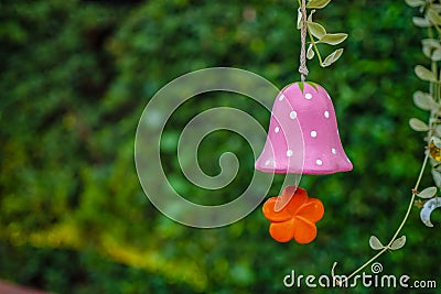 Colorful mobile flower shapes made of ceramic hanging in garden Stock Photo