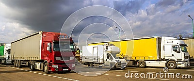 Colorful modern big semi-trucks and trailers of different makes Stock Photo