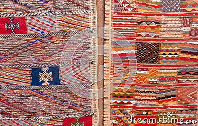 Colorful Moroccan Berber carpets hanging on adobe wall Stock Photo