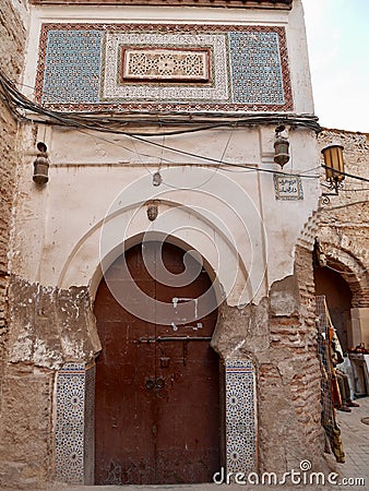 Colorful Moroccan entrance door with hand crafted stucco. Stock Photo