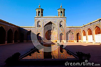 Colorful Mosque Nasir al Mulk in Shiraz. Reflection in water Stock Photo