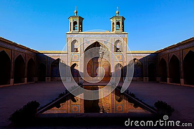 Colorful Mosque Nasir al Mulk in Shiraz. Reflection in water. Iran. Stock Photo