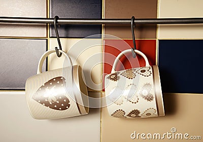 Colorful mugs on hooks Stock Photo