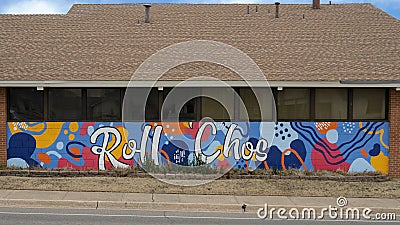Colorful mural featuring the words Roll 'Chos on a building on the campus of The Uiversity of Central Oklahoma in Edmond. Editorial Stock Photo