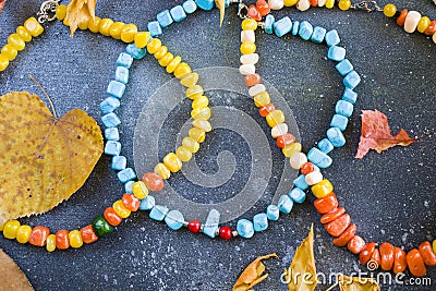 Colorful necklace and bracelet mix, beads and stone necklace, jewelry and blue background Stock Photo