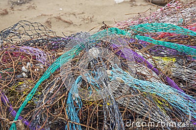 Colorful nets on beach. Trash in nature. Ecology crisis concept Stock Photo