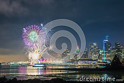 Colorful new year fireworks with Vancouver skyline seen from Stanley park Stock Photo