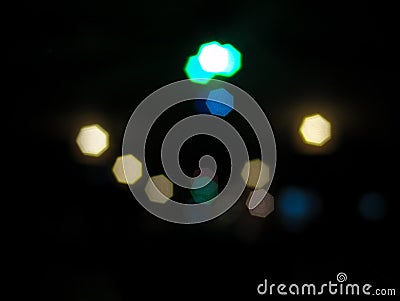 Colorful night lights in a city with hexagonal shapes on black background Stock Photo