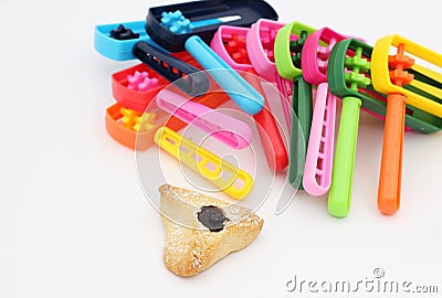 Colorful noisemakers and one Haman ear cookie Stock Photo