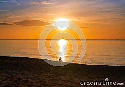 Colorful ocean beach sunrise with deep blue sky and sun reflection. orange and golden sunset sky calmness tranquil relaxing Stock Photo