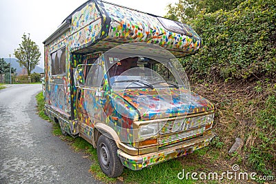 Colorful old camper parked outdoors Stock Photo