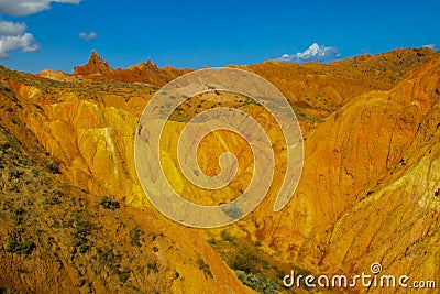 Red pinnacles of sandstone rocks at rainbow mountain canyon Stock Photo