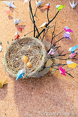 Colorful origami birds with colorful plastic pins and bird`s net Stock Photo