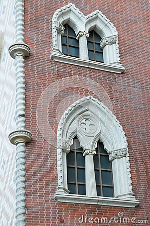 Colorful ornate windows on brick wall Stock Photo