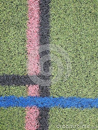 Aerial view green turf painted with black pink blue intersecting lines Stock Photo