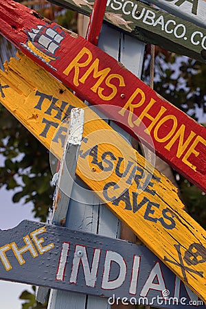 Colorful painted directional signs, Marina Cay, BVI Editorial Stock Photo