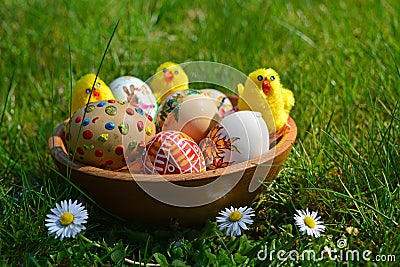 Colorful painted easter eggs and little sheep on a green grass Stock Photo