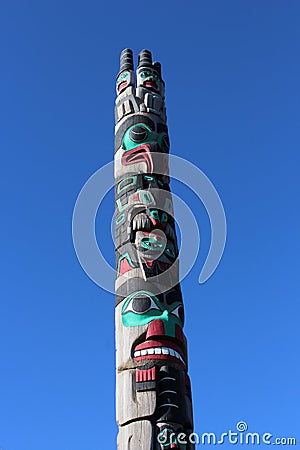 A colorful painted totem pole at Peace Arch Park Editorial Stock Photo