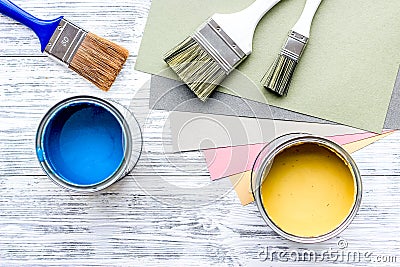 Colorful paints and brushes on grey wooden desk background top view copyspace Stock Photo