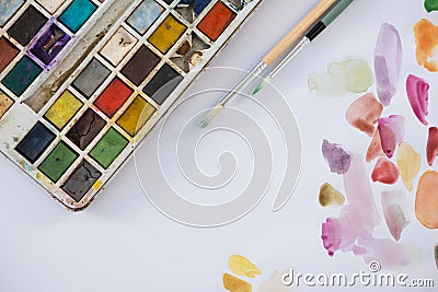 Colorful palette, paintbrushes and paper Stock Photo