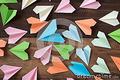 Colorful paper airplanes on wooden table background Stock Photo