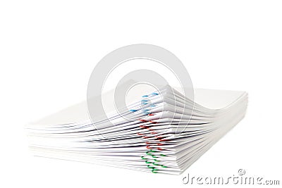 Colorful paper clip with pile of overload white paperwork isolated on white Stock Photo