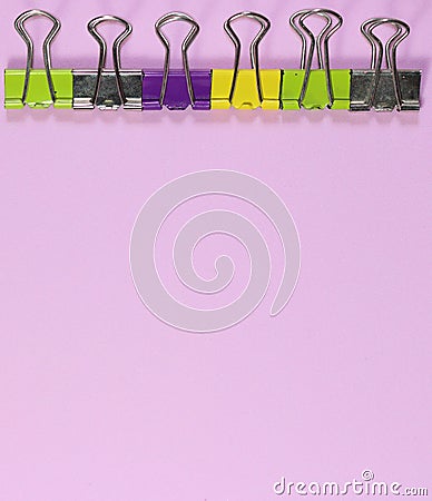 Colorful paper clip on pink millennial background. Space to insert the text. Stock Photo