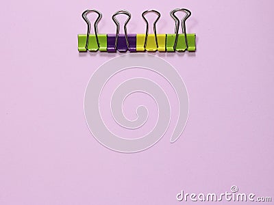 Colorful paper clip on pink millennial background. Space to insert the text. Stock Photo