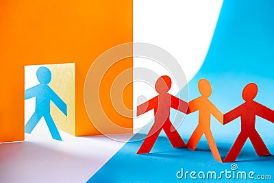 Colorful paper cut figures - group of people at the door, welcome or unwanted Stock Photo