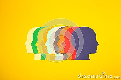 colorful paper heads facing left and the last blue head turned in the opposite direction, creative sobering solutions Stock Photo