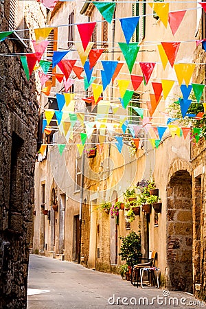 Colorful Party flags wave in a little alley Stock Photo