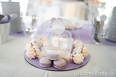 Colorful pastel cake macaron or macaroon on plate. Plate with sweet cakes on pink table. Sweets for the wedding wedding Stock Photo