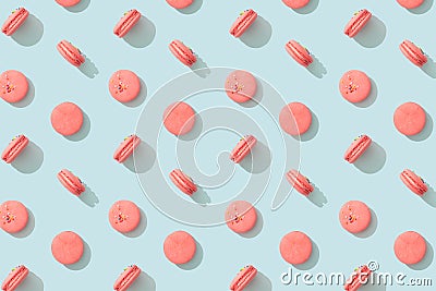 Colorful pattern cakes macaron or macaroon on blue pastel background. French almond cookies dessert, top view. Wrapping paper, Stock Photo