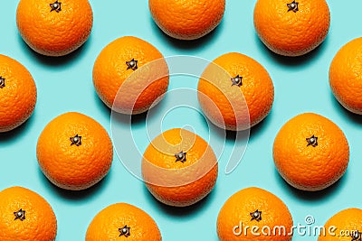 Colorful pattern of fresh mandarins orange fruits on background of cyan or aqua menthe of color. Stock Photo