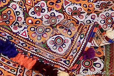 Colorful pattern and texture in cloth,Indian patchwork carpet in Rajasthan, Asia, Unidentified man embroidering cloth in Stock Photo