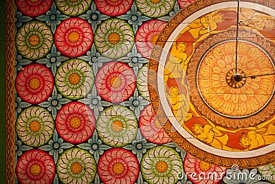 Colorful patterns of the old paintings, flowers and decor on wooden ceiling of Buddha ancient temple. Stock Photo