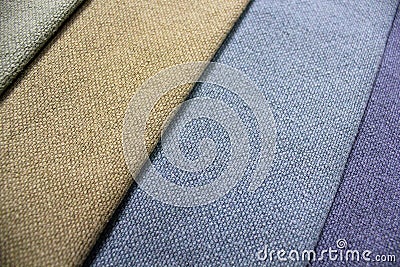 Colorful patterns of upholstery fabric. Close-up of samples of furniture fabric. Multicolored soft textile. Furniture industry. Stock Photo