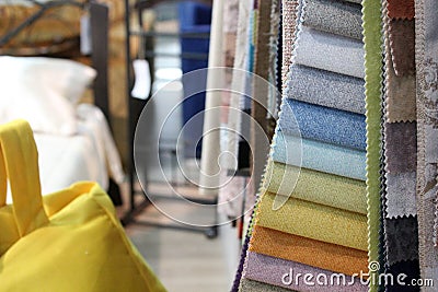 Colorful patterns of upholstery fabric. Close-up of samples of furniture fabric. Multicolored soft velour. Furniture industry. Bac Stock Photo