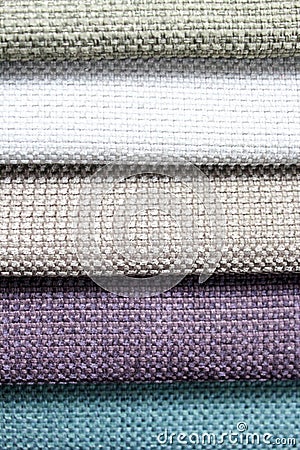 Colorful patterns of upholstery fabric. Close-up of samples of furniture fabric. Multicolored soft velour. Furniture industry. Bac Stock Photo