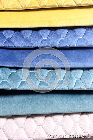 Colorful patterns of upholstery fabric. Close-up of samples of furniture fabric. Multicolored soft velour. Furniture industry. Bac Stock Photo