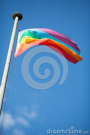 Colorful peace flag in blue sky Stock Photo