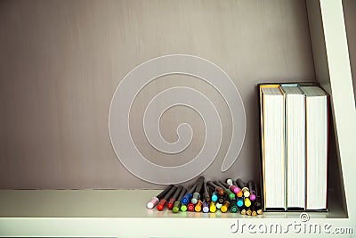 Colorful pen and books on shelve Stock Photo