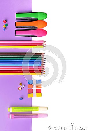 Colorful pencils and neon pens on mauve paper and white Stock Photo