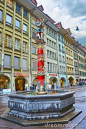 Colorful Pfeiferbrunnen fountain with sculpture of Minstrel located on Spitalgasse street, on March 31 in Bern, Switzerland Editorial Stock Photo