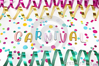 Letters of Carnival, paper streamers an confetti on white background. Stock Photo