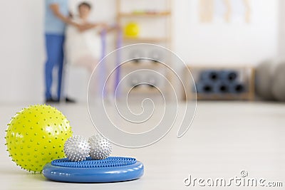 Colorful physiotherapy equipment on floor Stock Photo