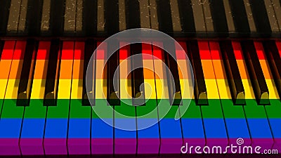 Colorful piano keyboard with keys in hues of rainbow. Stock Photo