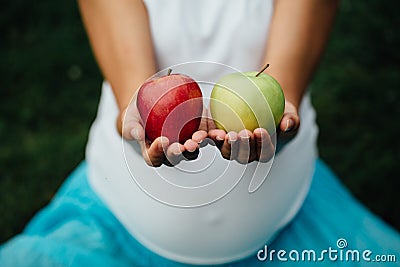 Colorful picture of female hands with green and red apple. Stock Photo